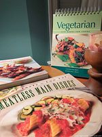 Three cookbooks and wooden candle holder grouped together