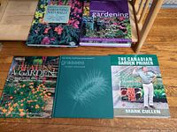 Front covers of the five gardening books laid out on floor