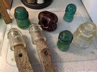 Group shot of seven insulators showing colors, two mounted on wood
