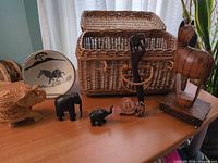 Overall lot view showing basket, plate, horse, elephants, mask