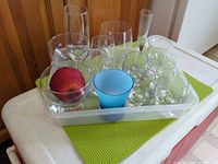 All 12 glasses inside plastic tray on cooler lid