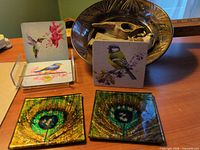 Group shot of dichroic glass coasters, bird card coasters, ceramic mirror plate, driftwood, bird figurine