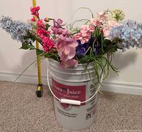 Bucket with assorted silk flowers arranged