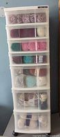 Front view of seven-drawer chest filled with yarn skeins