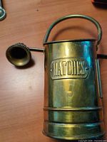 Brass match holder bucket with MATCHES plaque and candle snuffer cone visible
