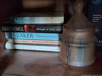 Books with ceramic jar beside them