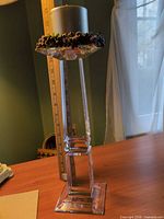 Full view of crystal candleholder with pillar candle showing height