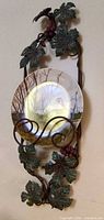 Plate mounted in vine-motif metal rack