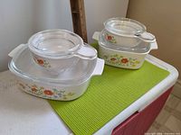 All four casserole dishes stacked with lids in place