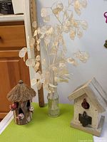 Group shot of both birdhouses and lunaria bottle