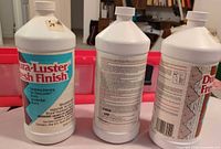 Front and back of three Dura-Luster Fresh Finish bottles with organizer in background