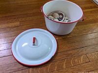 Pot with shells inside; lid placed beside