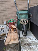 Entire lot showing wheelbarrow, bench, watering cans, birdhouse, candle holder, wreath