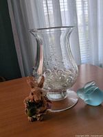 Group shot showing vase with marbles, brown rabbit figurine, blue frosted glass rabbit