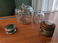 Overview showing both glass jars with lids, pewter piece and ceramic box