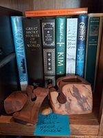 Books on shelf with cedar puzzle pieces in front