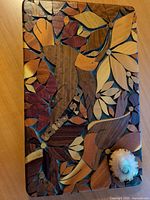 Front view showing intarsia floral design and seashell