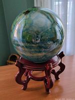Glass sphere on wooden stand showing overall appearance