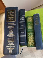 Spines of four hardcover books showing titles and publishers