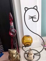 All four cat-themed decorative items grouped together