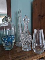 Group view of all glass and crystal pieces on wooden surface