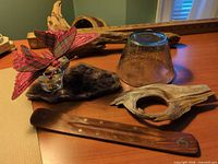 Group shot showing driftwood, stone slice with glass candle holder, etched glass bowl, incense holder, and fabric butterfly