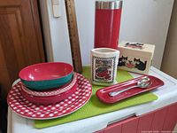 Overall view of dinner plates, bowls, tumbler, ceramic crock, wooden cat box, spoon rest and spoon