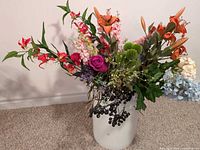 Full view of arrangement in bucket showing variety of flowers