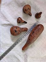 Five carved gourds with ruler for scale