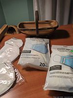 basket, N95 masks, two 20-pack face mask bags on table