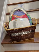 Basket filled with decanter, tray, plates and platter