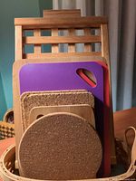 Front view of stacked boards and trivets in bamboo rack