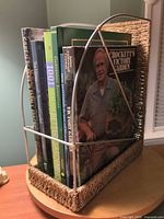 Books in rack, showing seagrass and metal construction and multiple book spines
