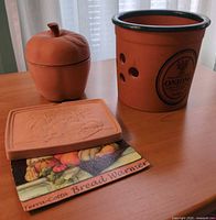 Group shot of onion crock, bread warmer tile, apple jar and informational card
