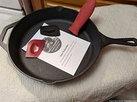 Top view of skillet with accessories and paperwork