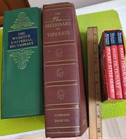 Front spines of all five books with ruler for scale