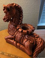 Right side view of bronze-painted terracotta horse figurine showing mane, body detail, recessed top opening with wax