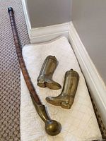 Wood cane and pair of brass boot bookends overview
