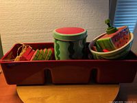 Overall lot inside red divided tray showing coasters, canister, bowl, dispenser