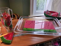Overall lot showing pitcher, glass, clear tray, ceramic bowl, wedge dish