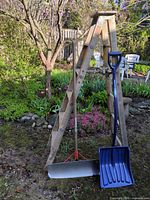 Full view of ladder and both shovels outdoors