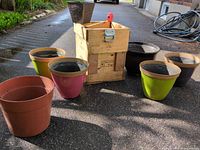 Overall lot showing crate and planters on driveway