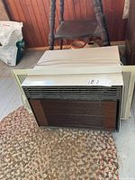 Full view of Electrohome window air conditioner lying on rug