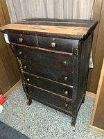 Full view of dresser front showing six drawers and worn finish