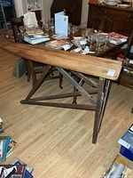 Full view of wooden ironing board set up in room