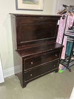 Front view of closed secretary showing drop-front and two drawers