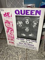 Front view of both posters showing Queen and partial Beatles poster