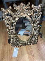 Front view showing full mirror and ornate frame