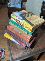 Stack of nine books showing spines and covers