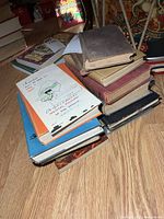 Stack of assorted books on floor